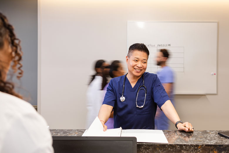 Male Healthcare Nurse at Hospital Check-in Desk